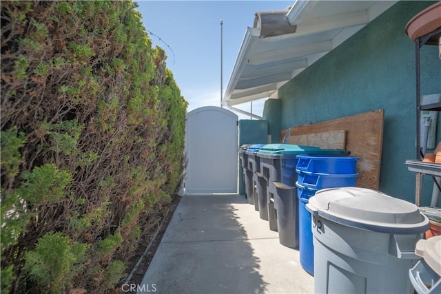 view of side of home featuring a gate and stucco siding