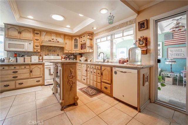 kitchen with a sink, white appliances, backsplash, light countertops, and ornamental molding