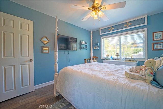 bedroom featuring a ceiling fan, dark wood-style flooring, and baseboards