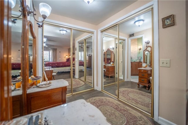 bathroom featuring wood finished floors, ceiling fan, and baseboards