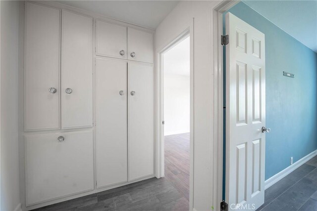 24492 Spartan St, Mission Viejo, CA 92691 - hallway with dark wood-type flooring and baseboards