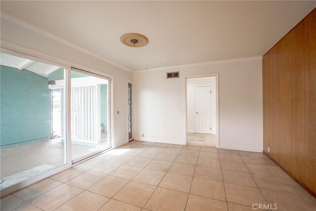 24492 Spartan St, Mission Viejo, CA 92691 - spare room with crown molding, wood walls, and light tile patterned floors