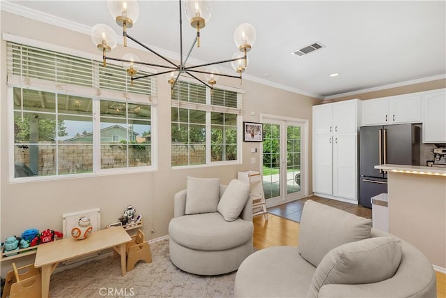 2548 S Young Ct, San Bernardino, CA 92408 - living room featuring visible vents, crown molding, baseboards, light wood finished floors, and a notable chandelier