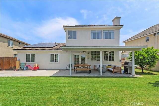 2548 S Young Ct, San Bernardino, CA 92408 - back of property with a lawn, a ceiling fan, and solar panels