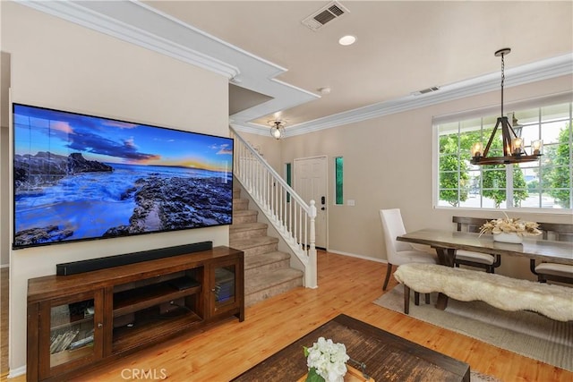 2548 S Young Ct, San Bernardino, CA 92408 - living room with crown molding, a chandelier, stairs, wood finished floors, and visible vents