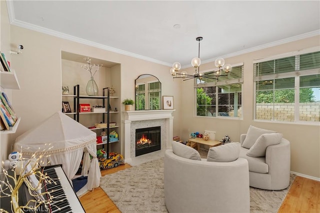 2548 S Young Ct, San Bernardino, CA 92408 - living area featuring an inviting chandelier, ornamental molding, wood finished floors, baseboards, and a fireplace with flush hearth