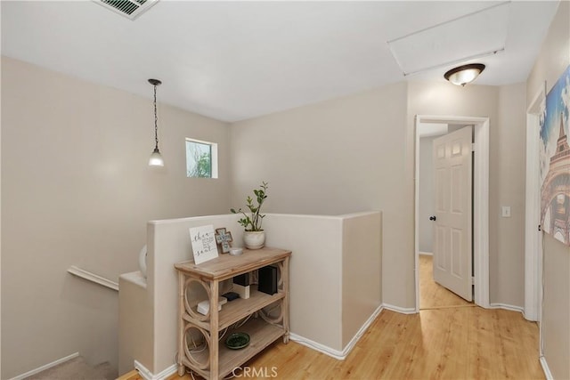2548 S Young Ct, San Bernardino, CA 92408 - hall featuring visible vents, light wood-style flooring, baseboards, and an upstairs landing