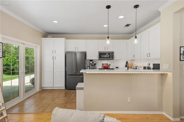 2548 S Young Ct, San Bernardino, CA 92408 - kitchen featuring visible vents, stainless steel microwave, a peninsula, high end fridge, and white cabinetry
