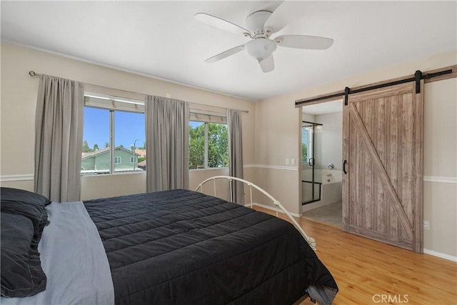 2548 S Young Ct, San Bernardino, CA 92408 - bedroom featuring baseboards, a barn door, ceiling fan, and light wood-style floors