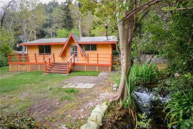 14109 Meadow Ln, Lytle Creek, CA 92358 - back of house with a lawn, a deck, and a wooded view