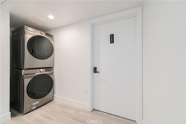 5652 La Mirada Ave, Los Angeles, CA 90038 - clothes washing area with stacked washer and clothes dryer, baseboards, light wood finished floors, and recessed lighting