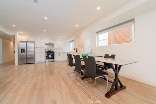 5652 La Mirada Ave, Los Angeles, CA 90038 - dining space featuring light wood-type flooring, baseboards, and recessed lighting