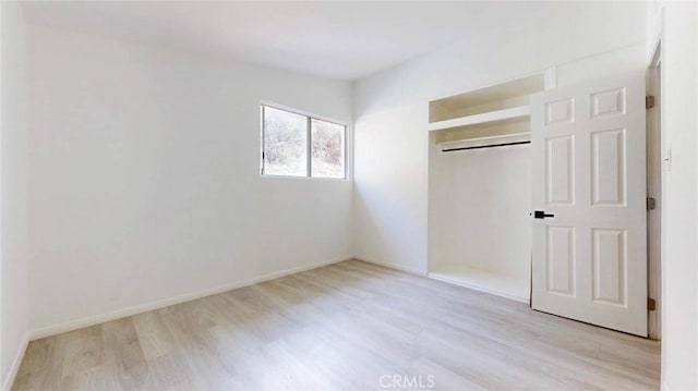 unfurnished bedroom featuring baseboards and wood finished floors