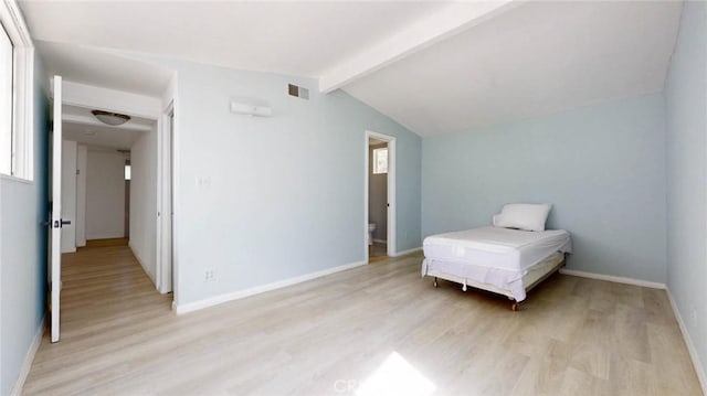 bedroom with lofted ceiling with beams, visible vents, light wood-style flooring, and baseboards