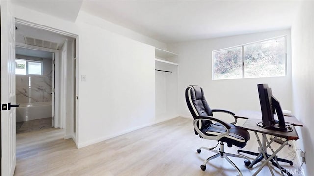 office with visible vents, light wood-style flooring, and baseboards