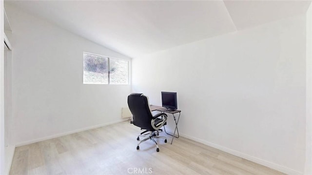 office space with vaulted ceiling, wood finished floors, and baseboards