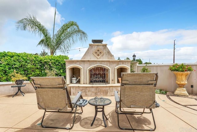 view of patio / terrace featuring a tiled fireplace