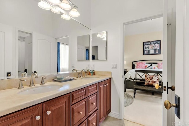 bathroom featuring double vanity, a sink, ensuite bath, and tile patterned flooring
