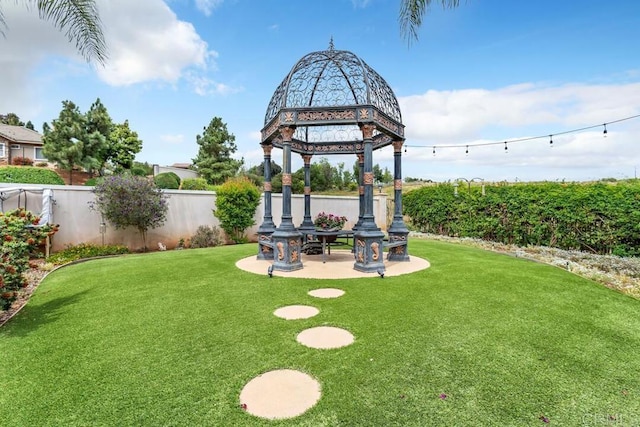 view of yard featuring a fenced backyard, a gazebo, and a patio area