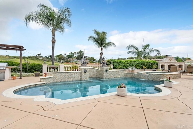 outdoor pool with a patio, an in ground hot tub, and area for grilling