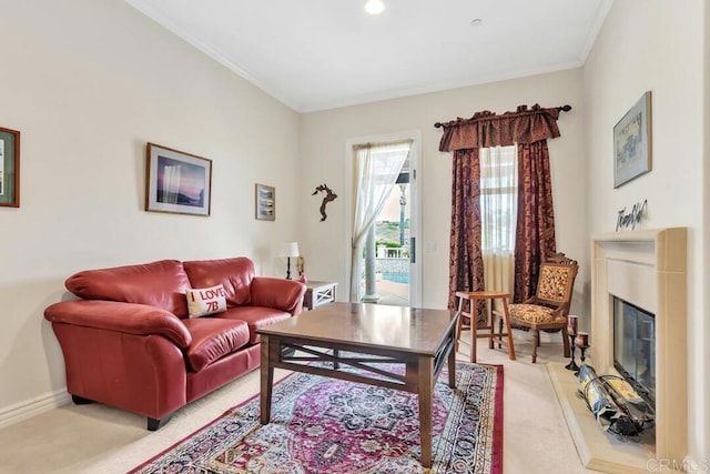 living area with light colored carpet, baseboards, a glass covered fireplace, and ornamental molding