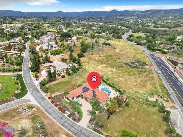 birds eye view of property with a residential view and a mountain view