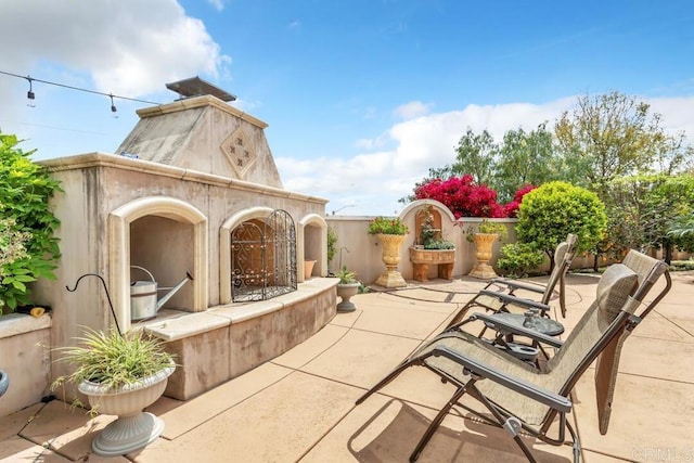 view of patio / terrace with a tile fireplace