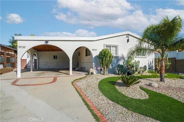 view of front of property with fence and stucco siding