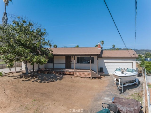 single story home with driveway, a porch, stucco siding, and a garage