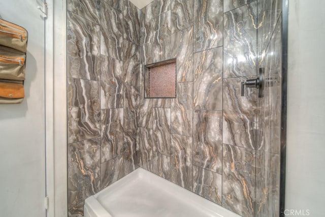 bathroom with tiled shower