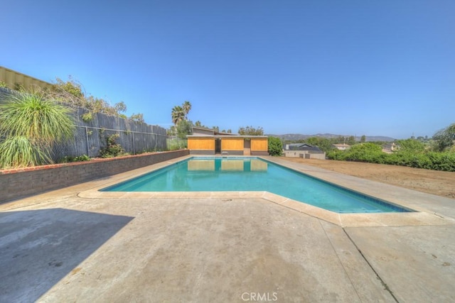 view of swimming pool with fence, a fenced in pool, and a patio area