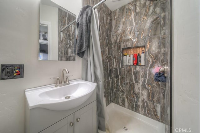 bathroom featuring a stall shower and vanity