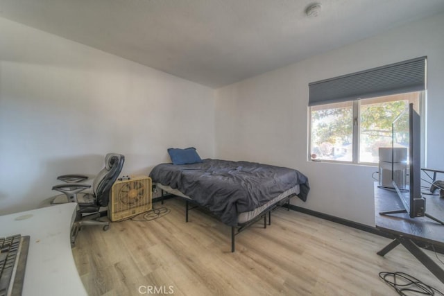 bedroom with baseboards and light wood-style floors