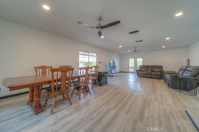 dining room with a healthy amount of sunlight, visible vents, ceiling fan, and light wood-style floors