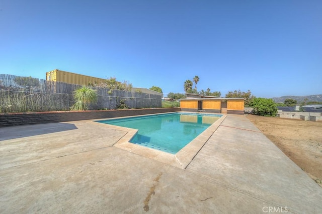 view of swimming pool with fence, a fenced in pool, and a patio area
