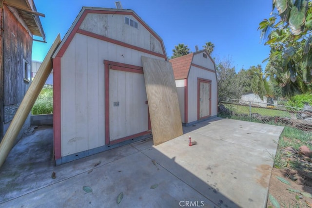 view of shed with fence