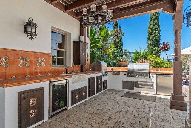 view of patio with beverage cooler, grilling area, and area for grilling