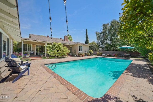 view of pool with a fenced in pool, a patio area, and a fenced backyard