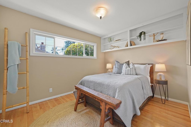 bedroom with wood finished floors and baseboards