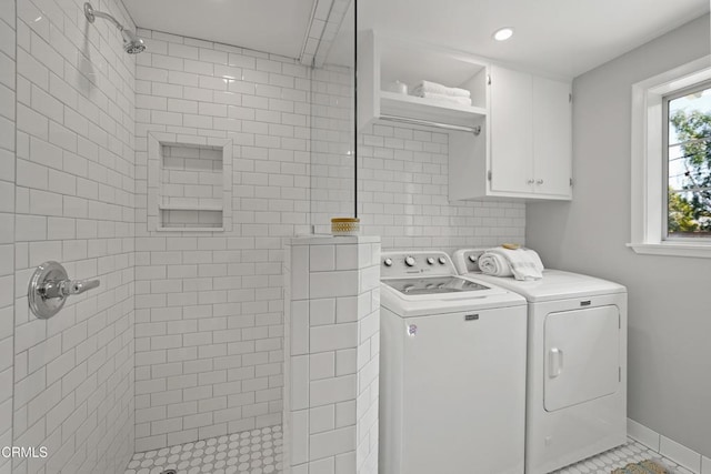 laundry room featuring recessed lighting, light tile patterned floors, cabinet space, washing machine and clothes dryer, and baseboards
