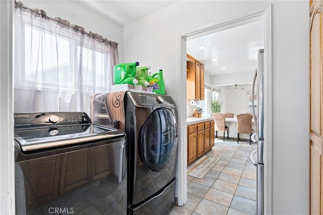 washroom with light tile patterned floors, independent washer and dryer, and laundry area