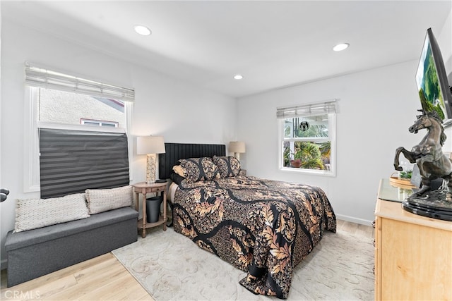 bedroom featuring recessed lighting, multiple windows, wood finished floors, and baseboards
