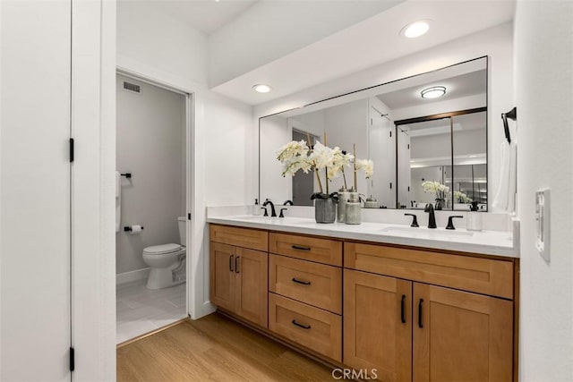 4 Woodlake, Irvine, CA 92604 - full bathroom with toilet, double vanity, wood finished floors, and recessed lighting