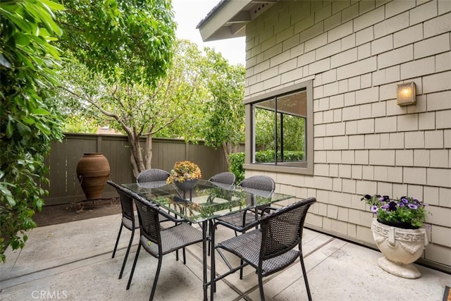 view of patio / terrace featuring fence and outdoor dining area