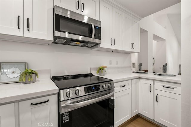 4 Woodlake, Irvine, CA 92604 - kitchen with stainless steel appliances, white cabinetry, and wood finished floors