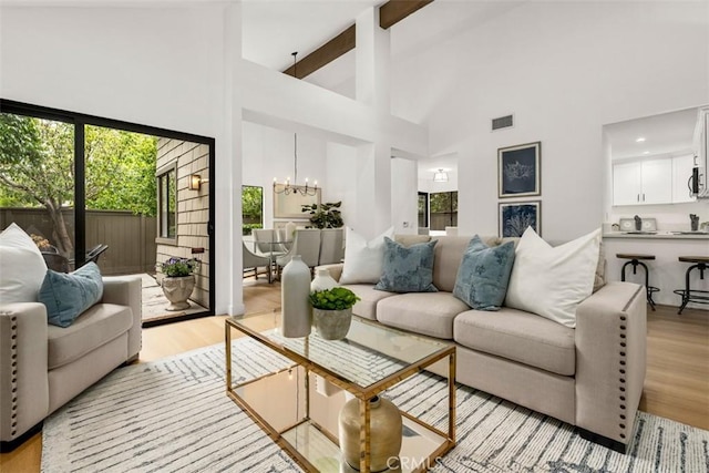 4 Woodlake, Irvine, CA 92604 - living room with high vaulted ceiling, a chandelier, light wood finished floors, and beam ceiling