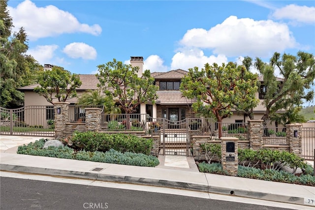 27561 Silver Creek Dr, San Juan Capistrano, CA 92675 - view of front of property with a chimney, stucco siding, fence private yard, and a gate