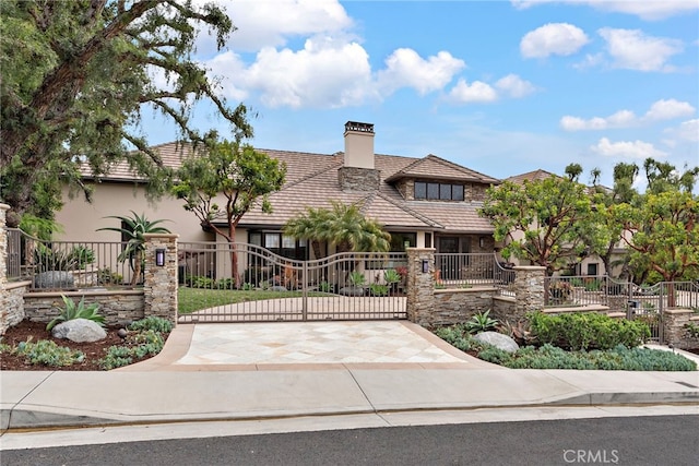 27561 Silver Creek Dr, San Juan Capistrano, CA 92675 - tudor house featuring a chimney, a gate, and a fenced front yard