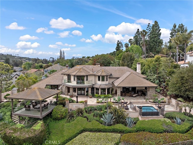 27561 Silver Creek Dr, San Juan Capistrano, CA 92675 - rear view of property with a tile roof, a balcony, a patio area, a chimney, and stucco siding