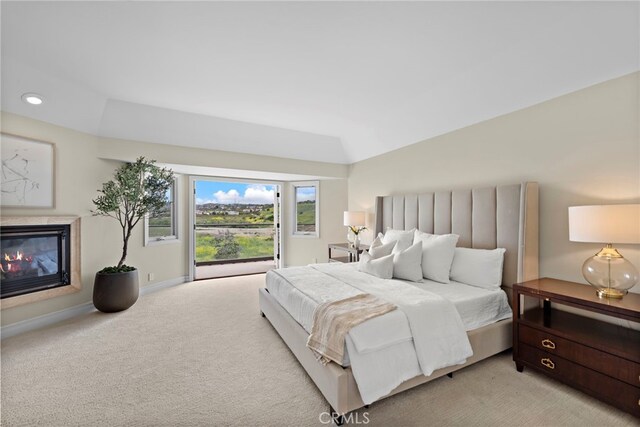 27561 Silver Creek Dr, San Juan Capistrano, CA 92675 - bedroom with light colored carpet, a glass covered fireplace, access to outside, and baseboards